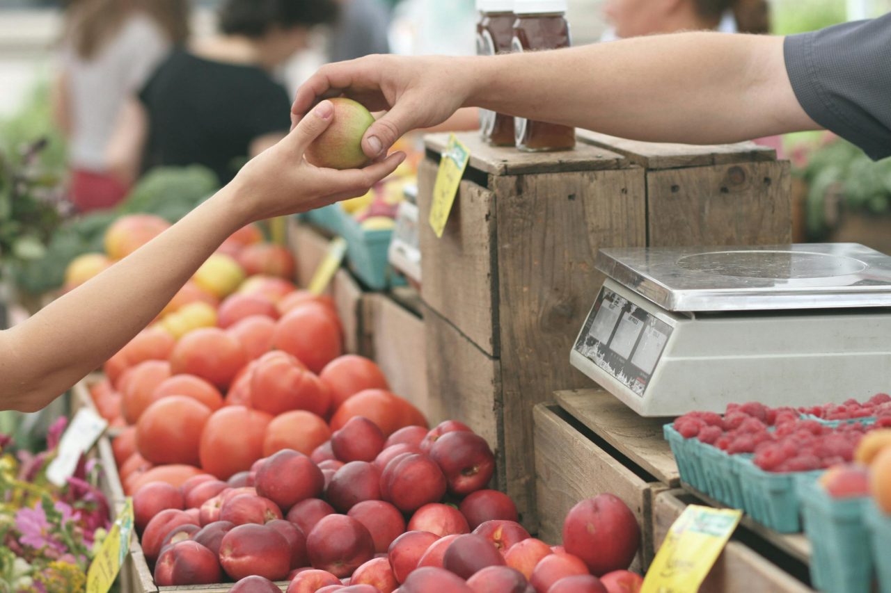 A man purchasing an apple