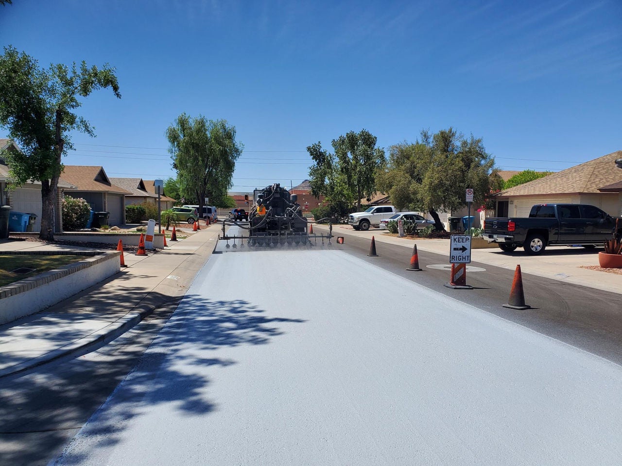 Crews applying Cool Pavement on roadway