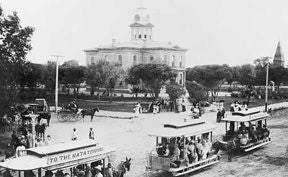 Horse-drawn streetcars pass by the old courthouse in the 1890s.