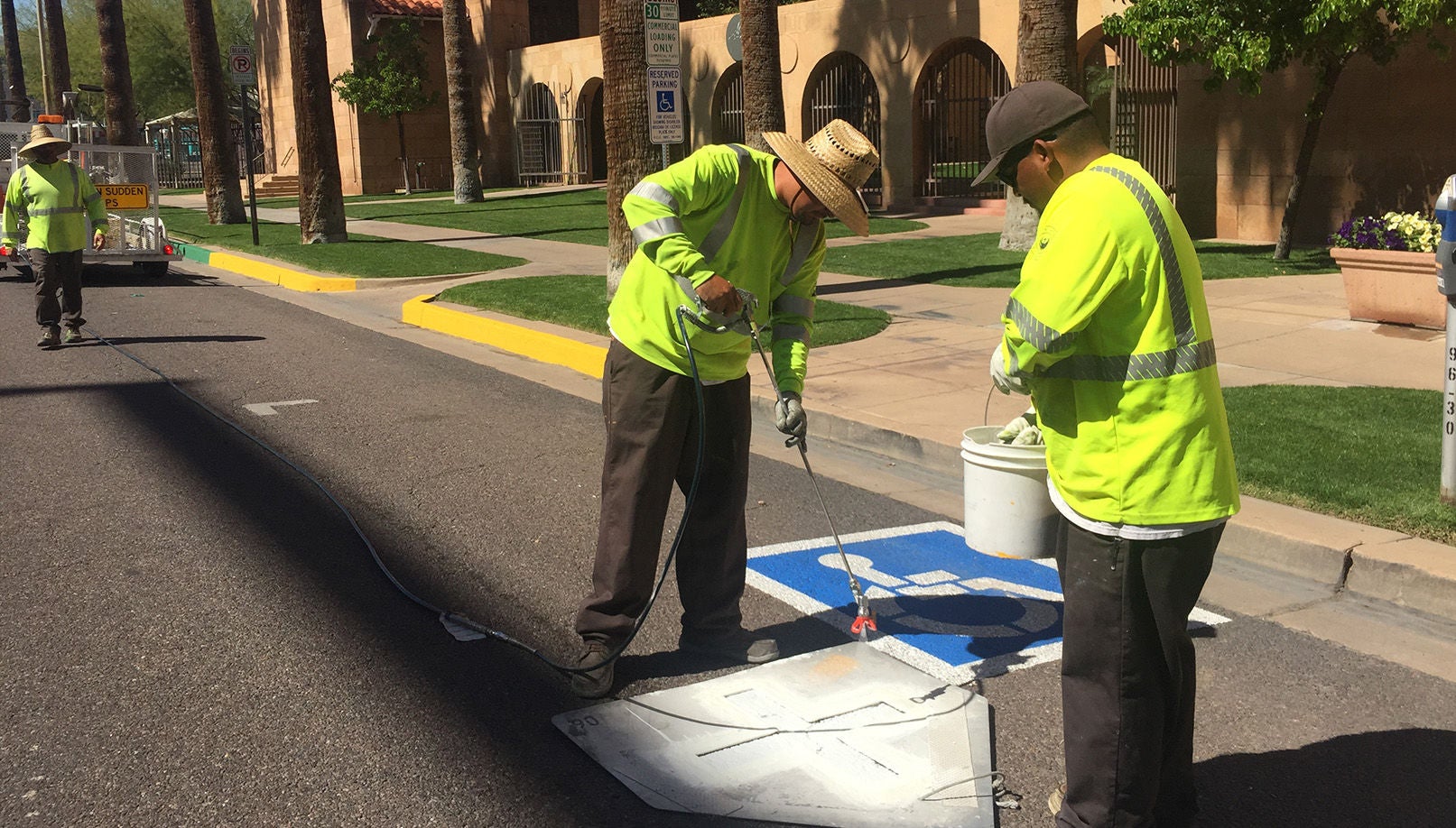 workers painting street markers 
