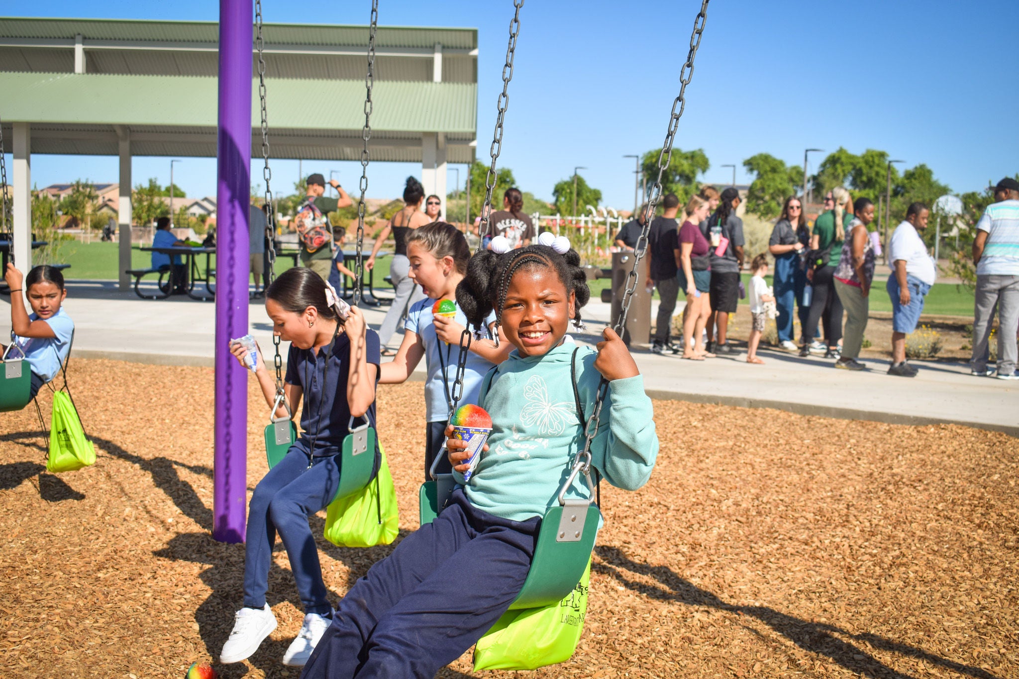 Children sitting on playground equipment. 