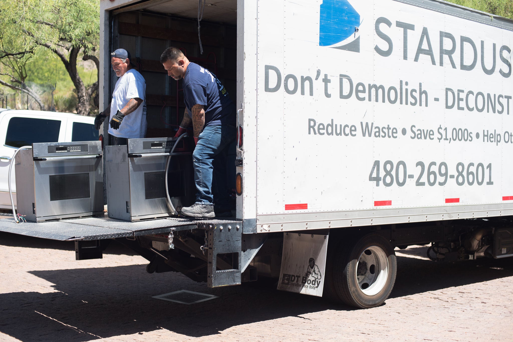 Used ovens being loaded onto a Stardust box truck