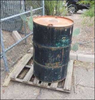 Drum stored outside uncovered and without secondary containment.