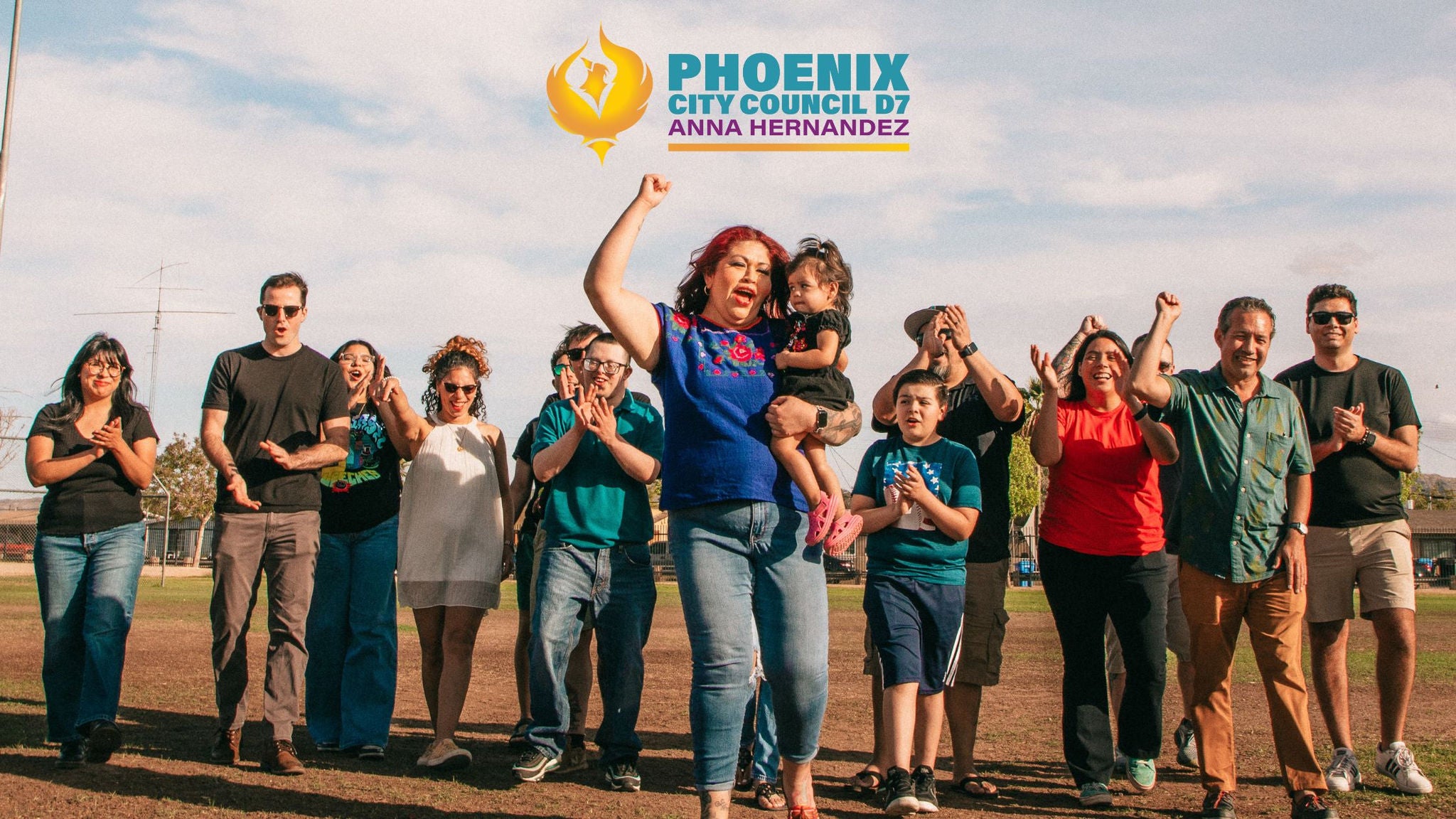 Councilmember Anna Hernandez stands with arms crossed in front of Phoenix City Hall, beneath the building’s striking sun sculpture. Dressed in a bold pink blazer, she exudes strength and determination, framed by the towering architecture and reflections of downtown Phoenix.