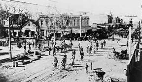 Photo of cyclists at Washington and First streets in the late 1880s.
