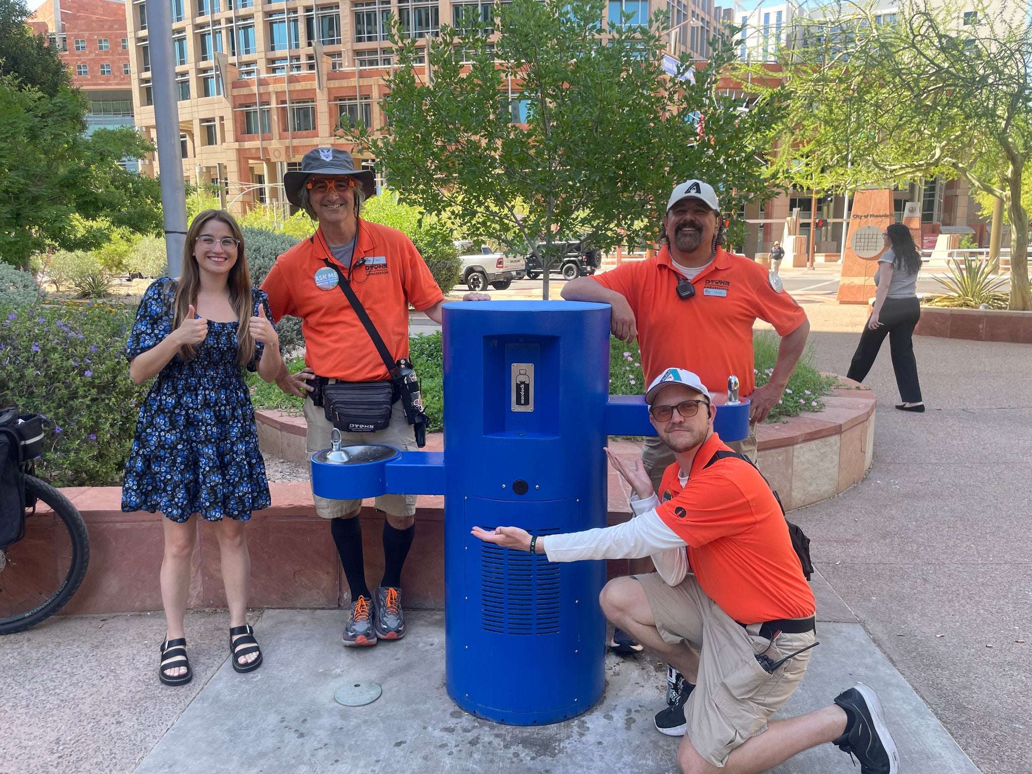 Staff standing next to a water fountain