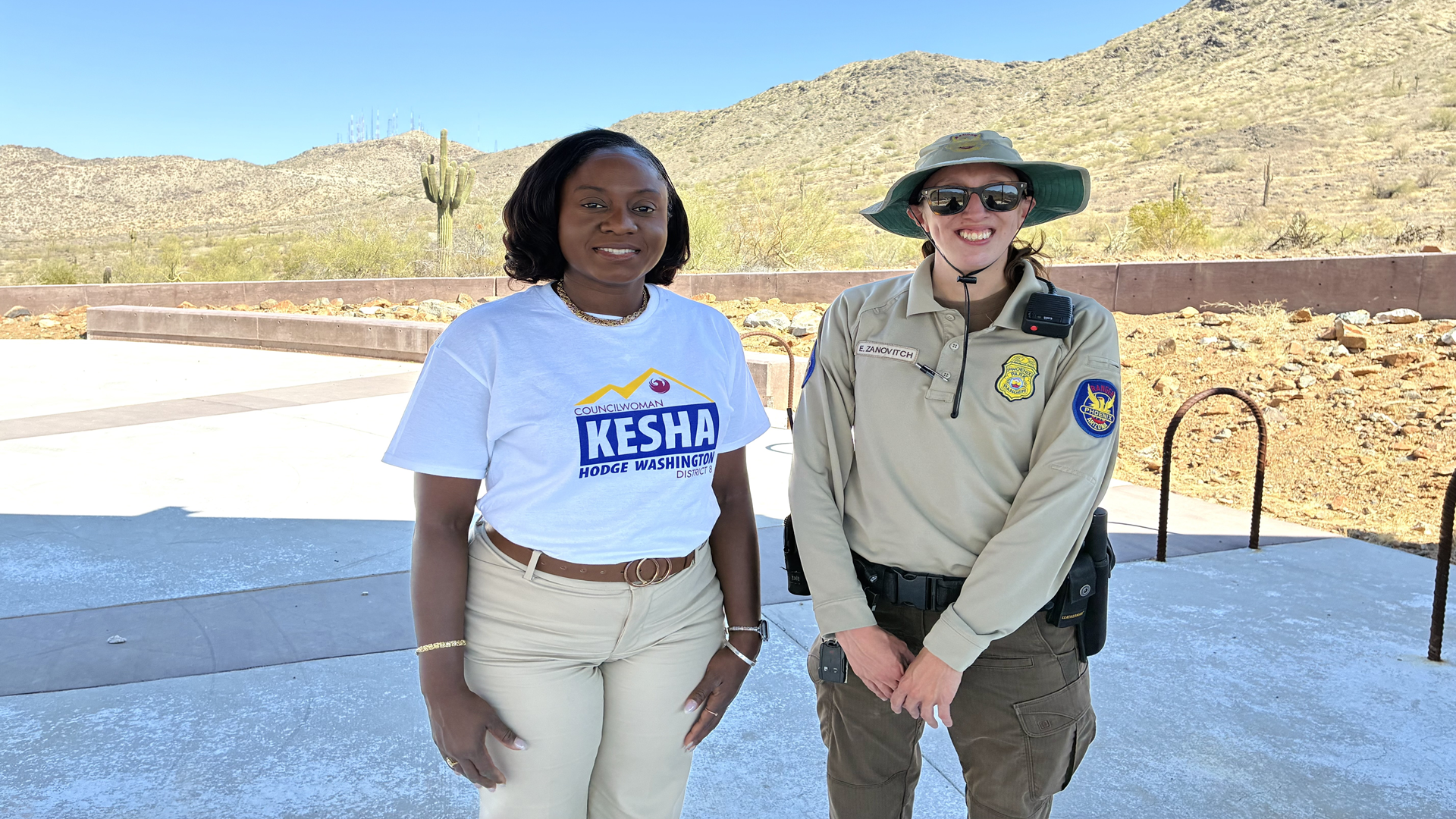 Councilwoman Kesha Hodge Washington stands next to a Phoenix Park Ranger at a trailhead.