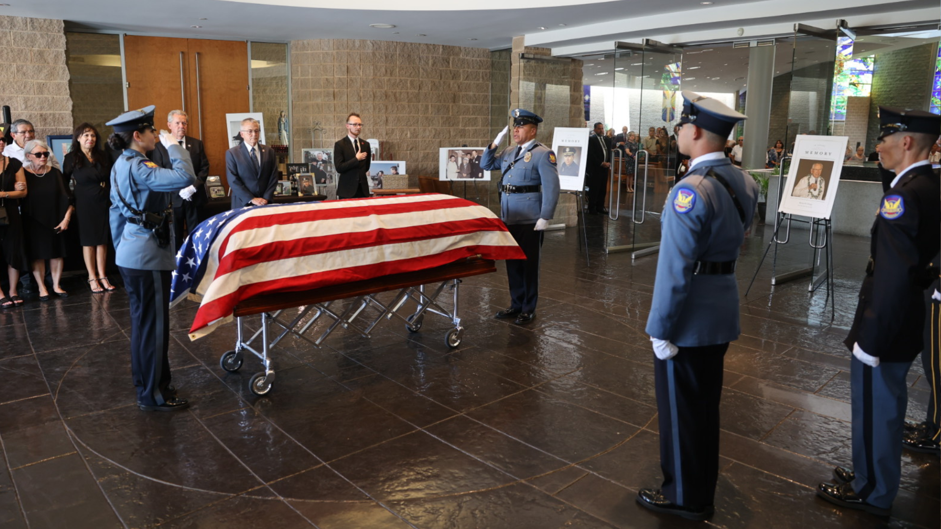 Honor Guard salutes Chief Ortega's casket. 