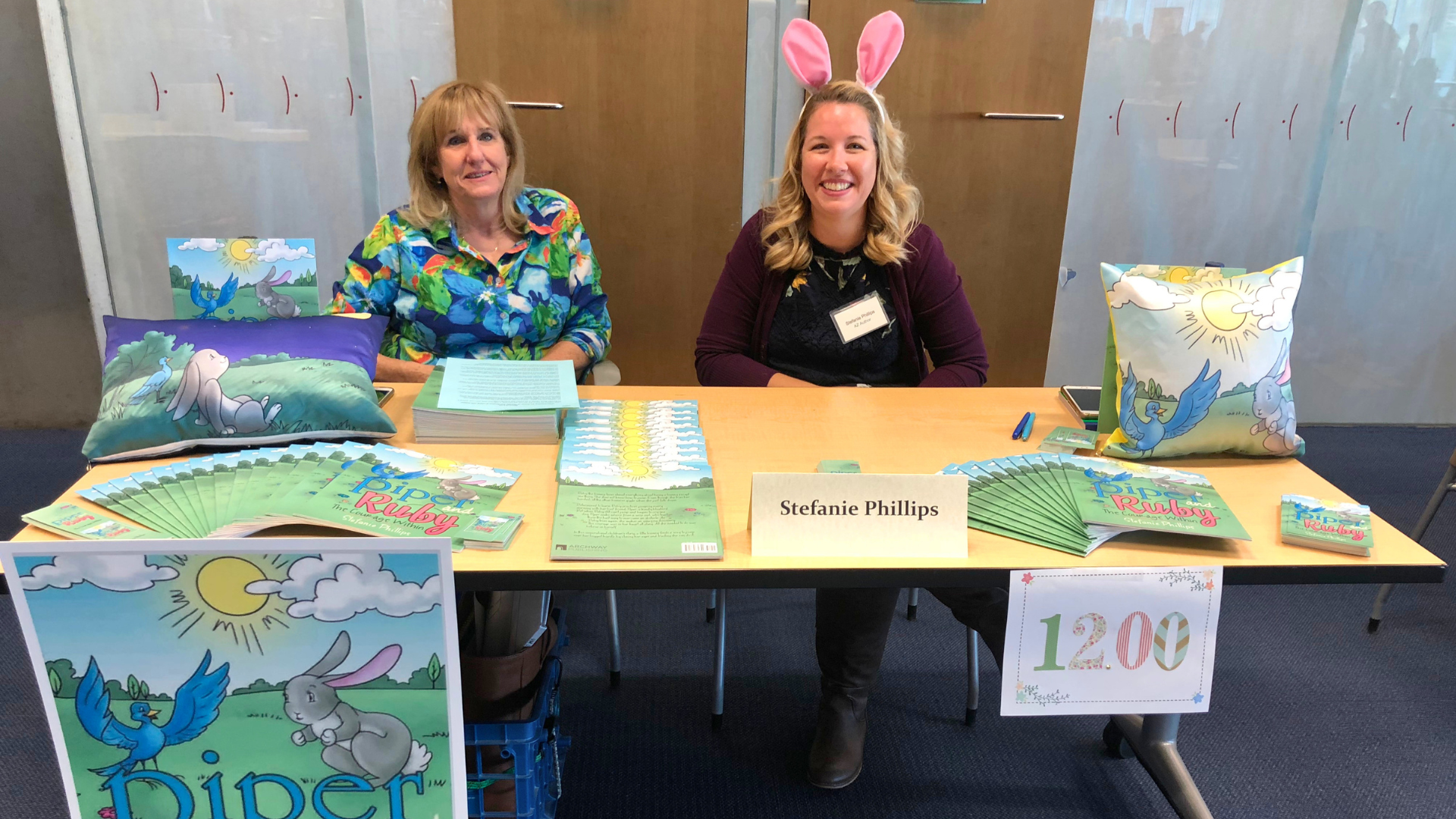 Photo of local author Stefanie Phillips tabling at a Phoenix Public Library Local Author Fair.