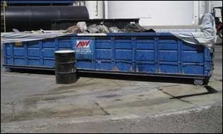 Roll-off dumpster is not covered and is leaking.