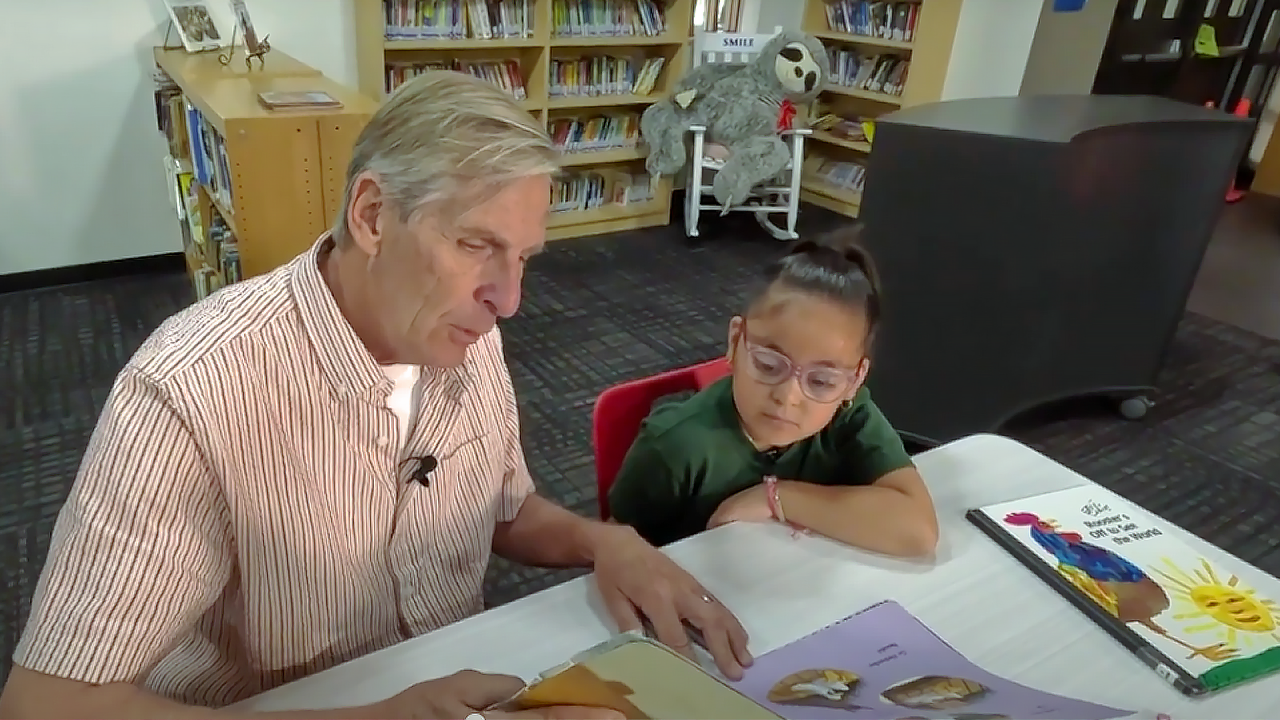 Adults tutor youth in the Volunteer Corps.